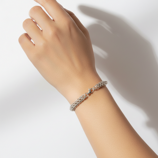 Silver braided bracelet on a white background