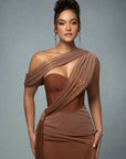 Woman wearing a brown dress with a draped design against a gray background
