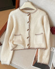 Beige cardigan with brown buttons on a hanger