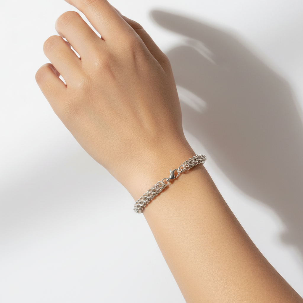 Silver braided bracelet on a white background