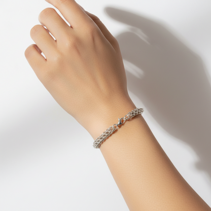 Silver braided bracelet on a white background