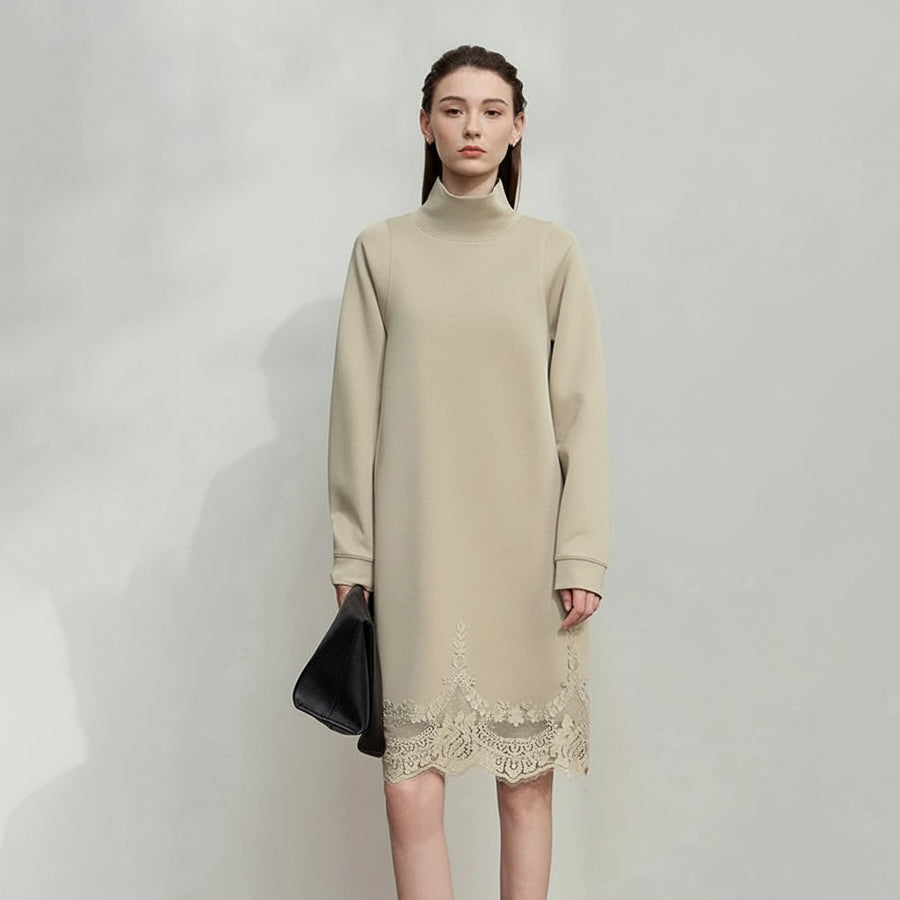 Woman wearing a beige dress with lace details, holding a black clutch, on a plain background with AMII branding.