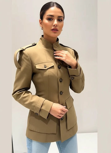 Person wearing a beige trench coat taking a mirror selfie.