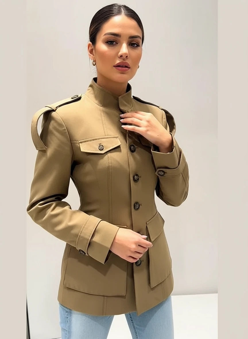 Person wearing a beige trench coat taking a mirror selfie.