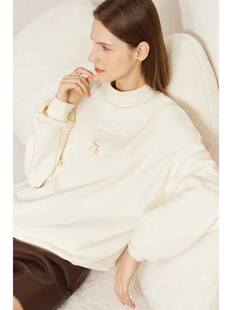 Woman wrapped in a white blanket sitting on a chair