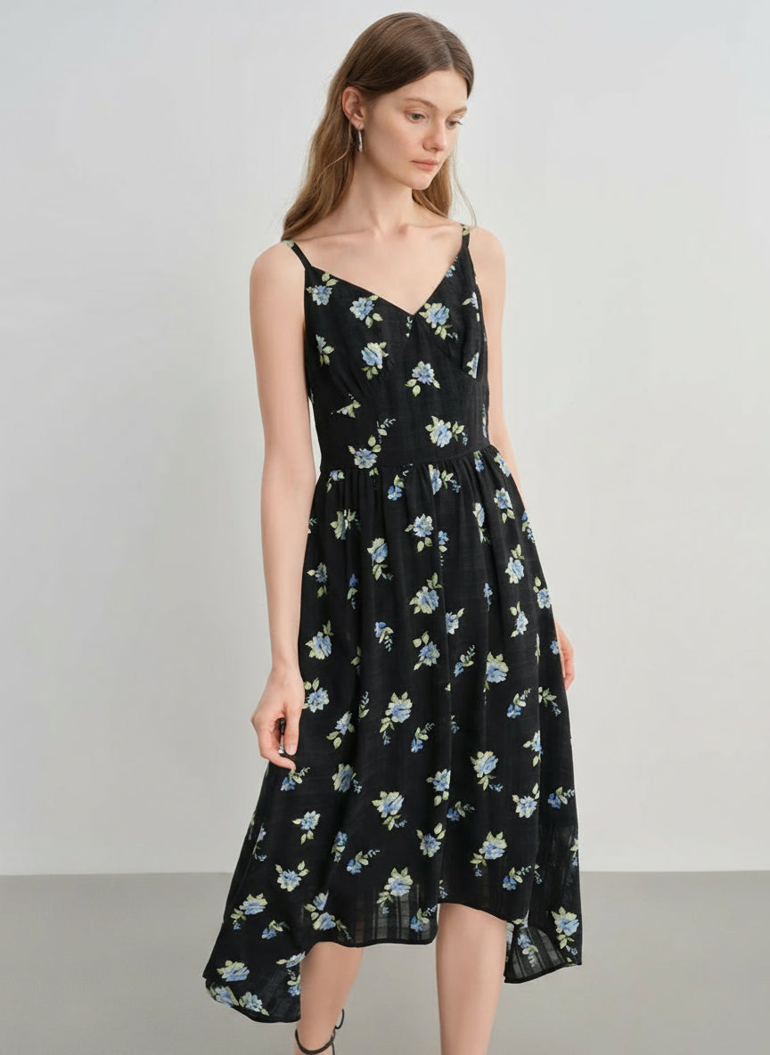 Woman wearing a black floral dress on a gray background