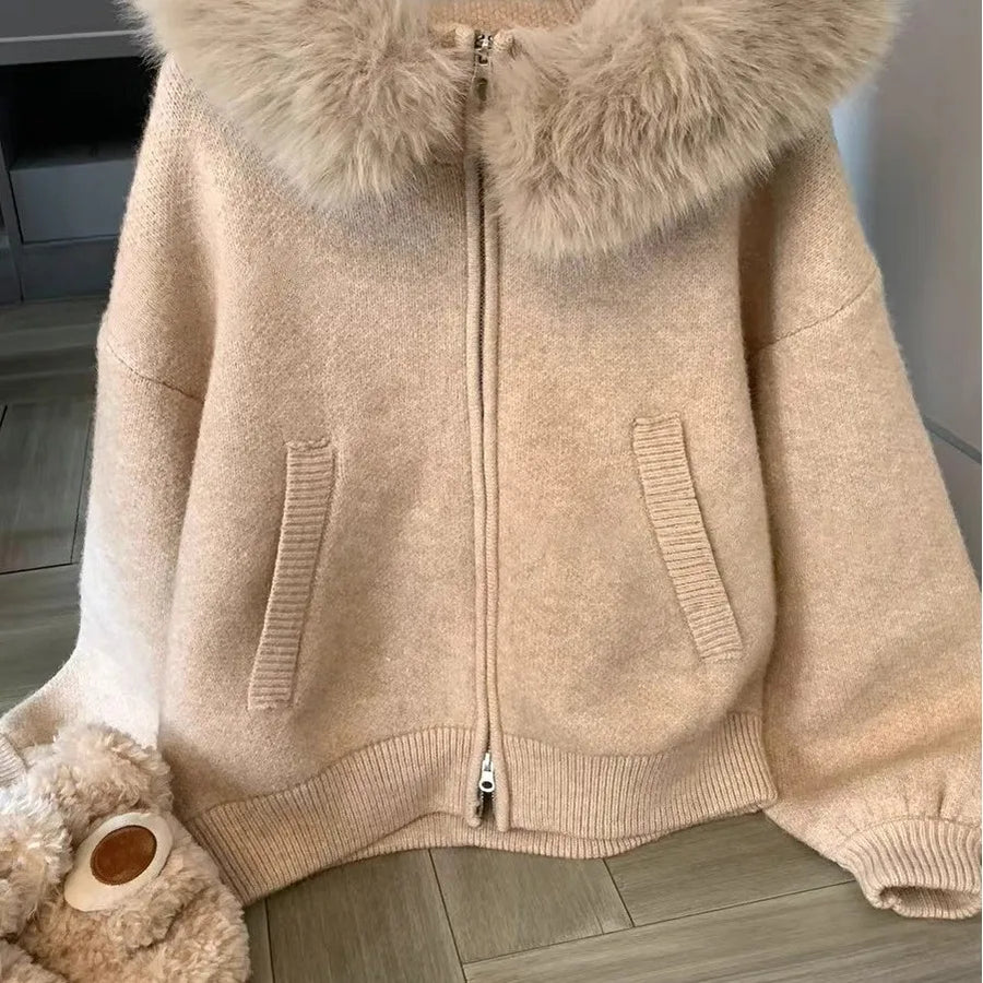 Beige jacket with fur hood on a wooden floor