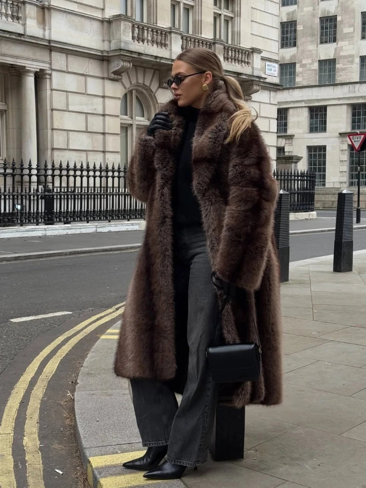 Person wearing a brown fur coat on a city street