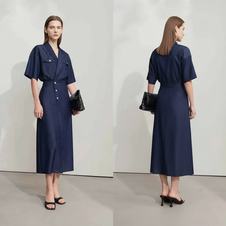 Woman wearing a navy blue dress with a white background, featuring the brand 'Amii'.