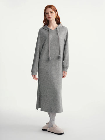 Woman wearing a gray hooded dress on a white background