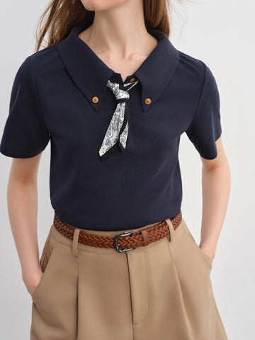 Navy blue shirt with a bow tie and beige pants on a white background