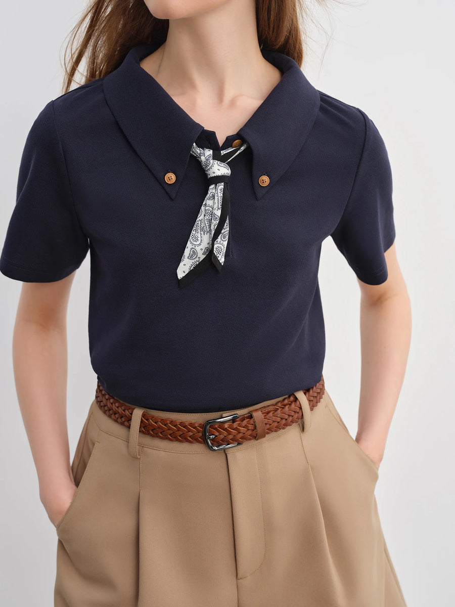 Navy blue shirt with a bow tie and beige pants on a white background