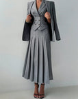 Gray suit with a skirt on a plain background