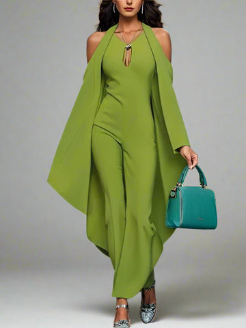 Woman in a green outfit holding a blue handbag on a blurred background