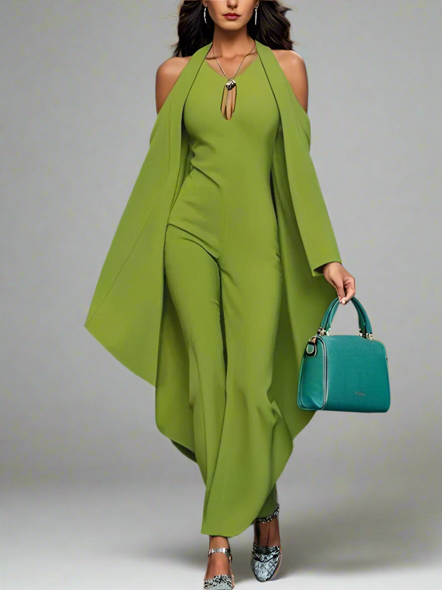 Woman in a green outfit holding a blue handbag on a blurred background