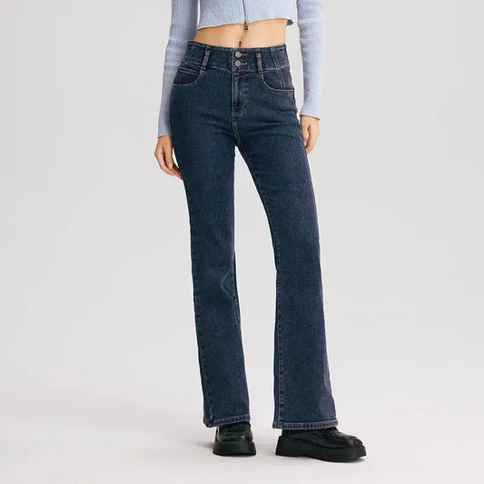Person wearing dark blue jeans on a light gray background