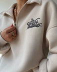Beige hoodie with 'Wild Buffalo' logo worn by a person