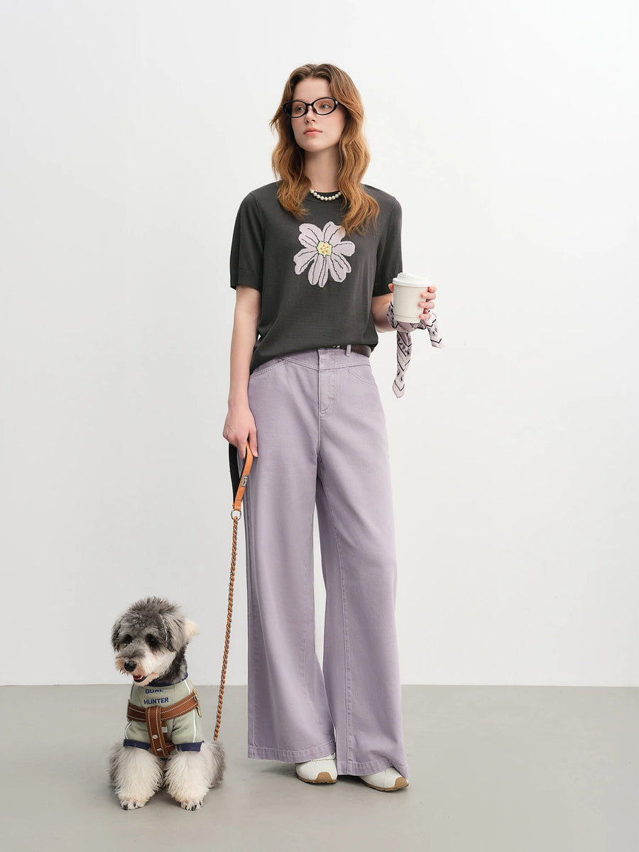 Woman holding a coffee cup with a dog on a leash against a white background