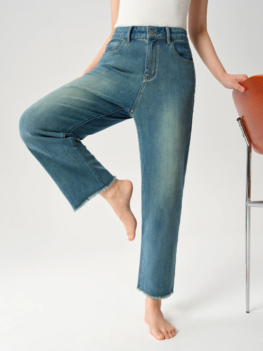 Person wearing blue jeans on a white background