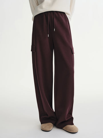 Brown cargo pants worn by a person on a white background