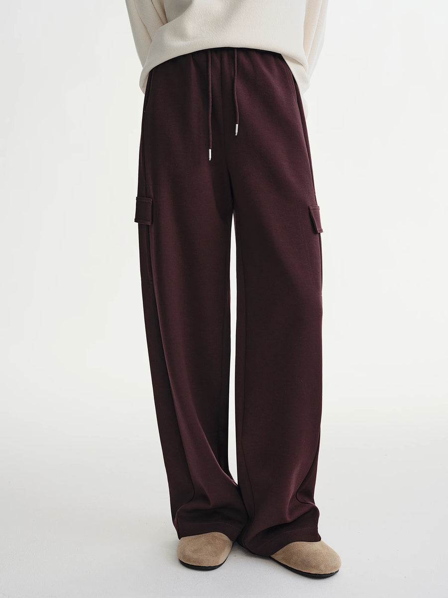 Brown cargo pants worn by a person on a white background