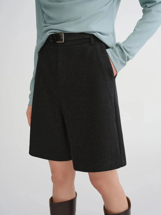 Person wearing a light blue top and black skirt 