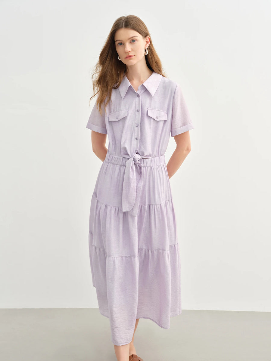 Woman wearing a light purple dress with a white background