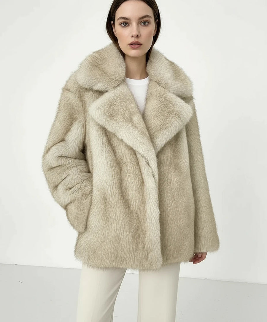 Beige faux fur coat on a hanger against a white background
