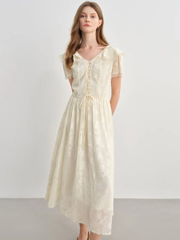 Woman wearing a beige dress against a white background