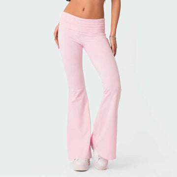 Person wearing light pink flared pants on a white background