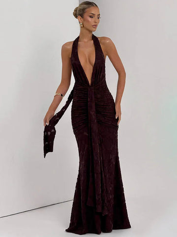 Woman wearing a deep neckline evening gown with a plain background