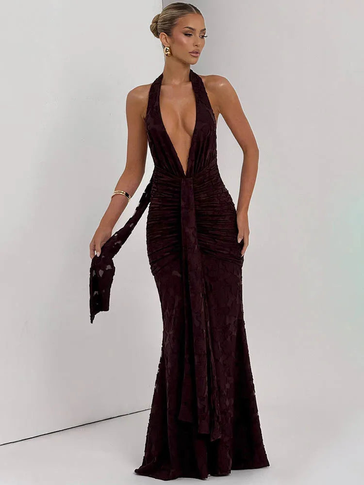 Woman wearing a deep neckline evening gown with a plain background