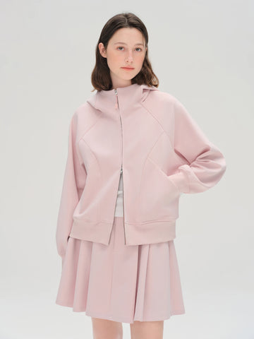 Person wearing a pink outfit on a white background