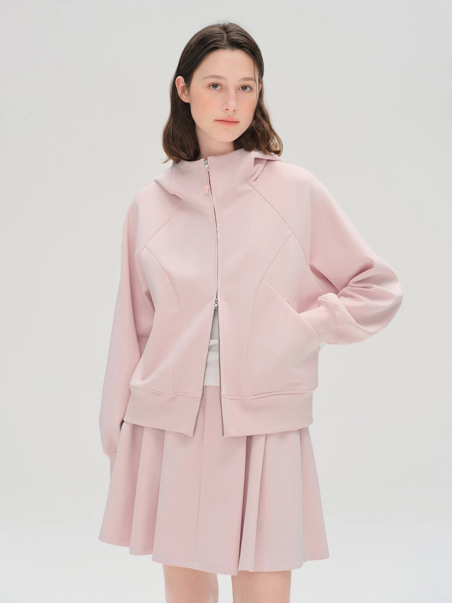 Person wearing a pink outfit on a white background