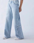 Light blue jeans with a bow design on a white background