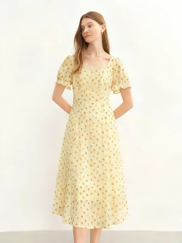Woman wearing a yellow floral dress on a white background with 'DUSHU' branding.
