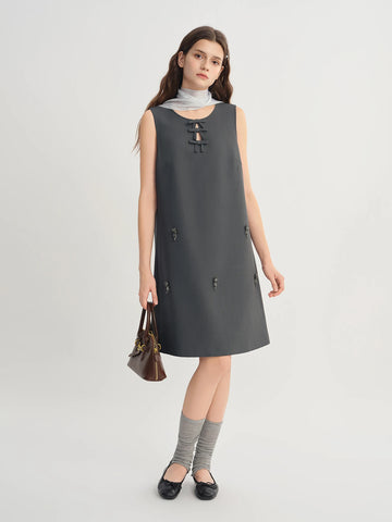 Woman wearing a gray sleeveless dress on a white background