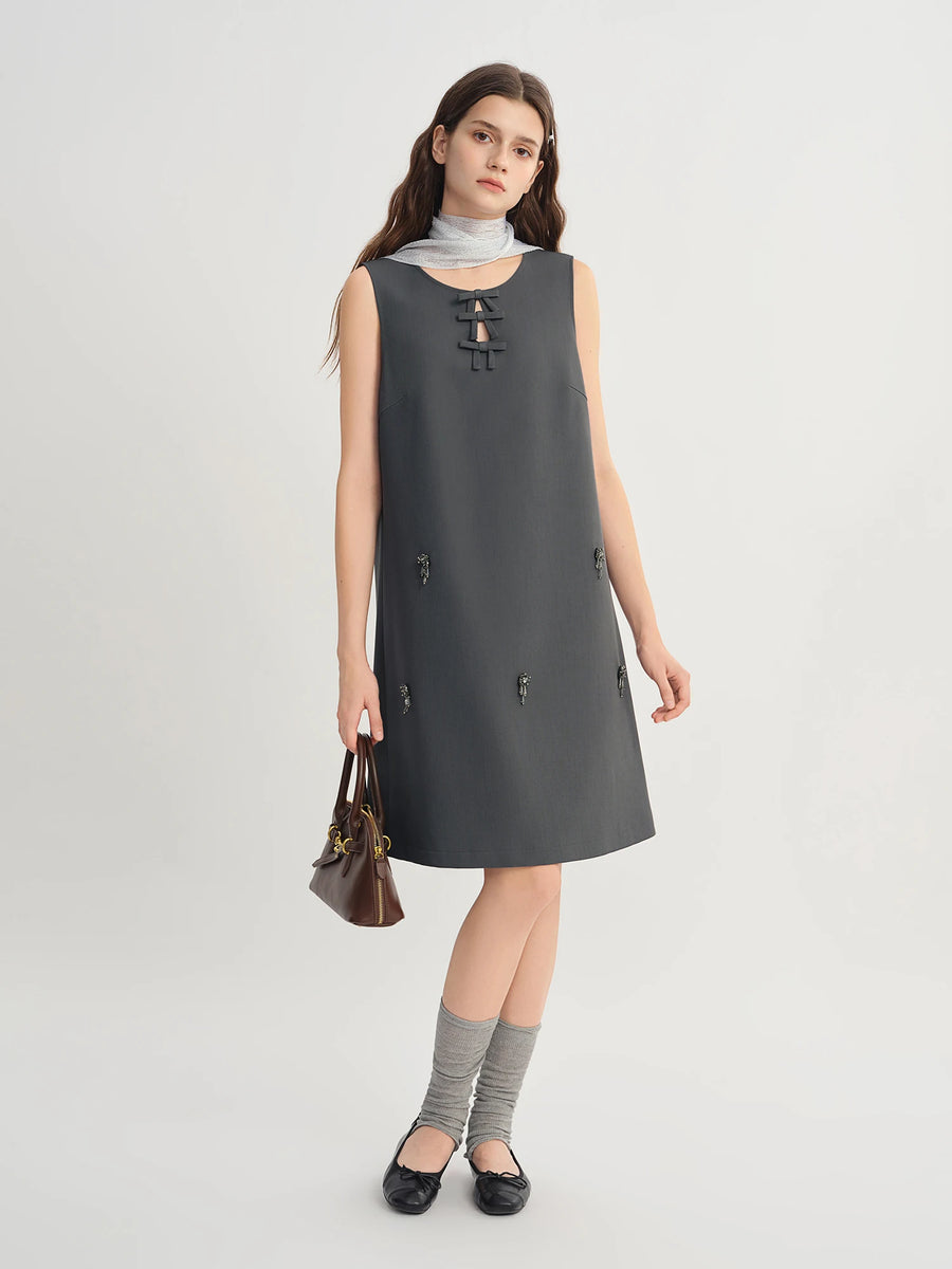 Woman wearing a gray sleeveless dress on a white background