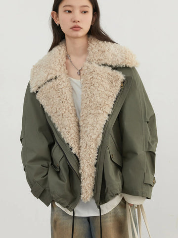 Person wearing a green jacket with a beige fur collar on a white background