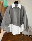 Gray sweater with white collar and cuffs on a hanger