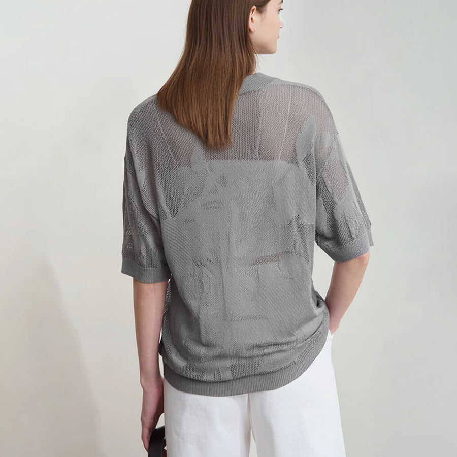 Person wearing a gray mesh top with a plain background, featuring the brand 'Amii'.