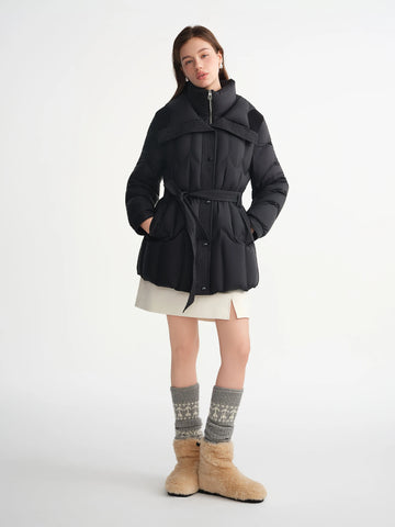 Woman wearing a black coat with a white background