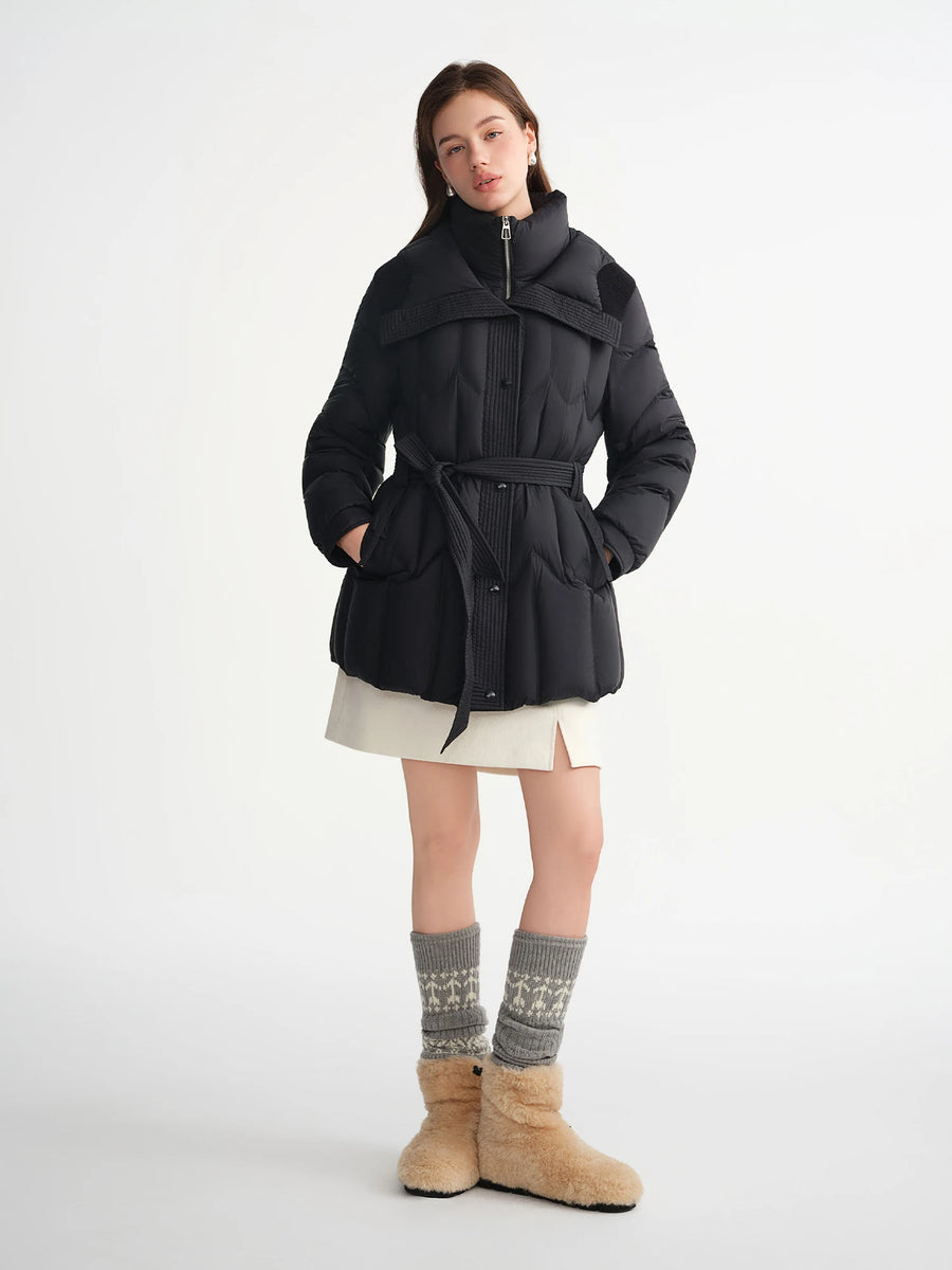 Woman wearing a black coat with a white background