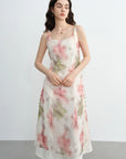 Woman wearing a floral dress against a plain background