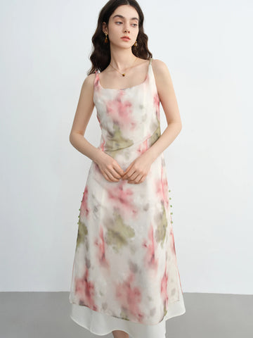 Woman wearing a floral dress against a plain background