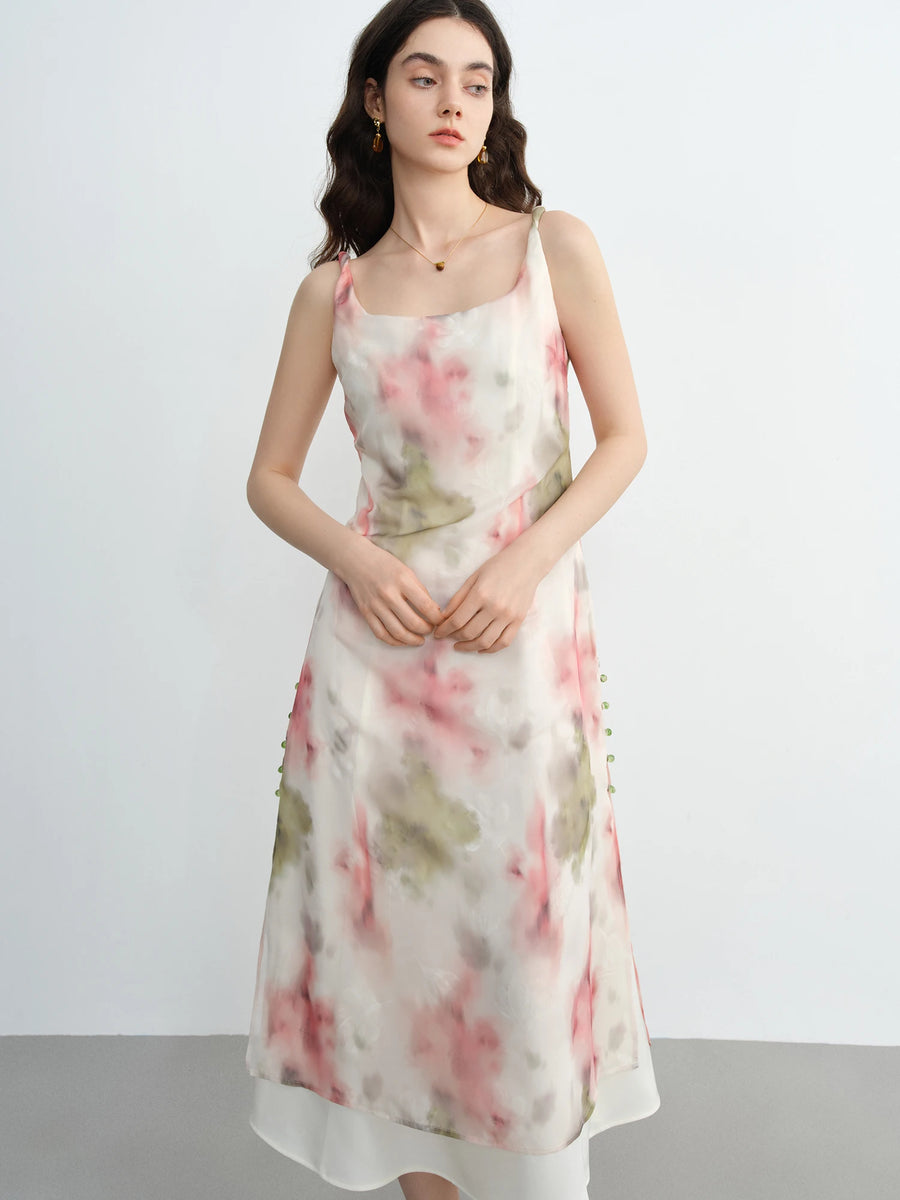 Woman wearing a floral dress against a plain background