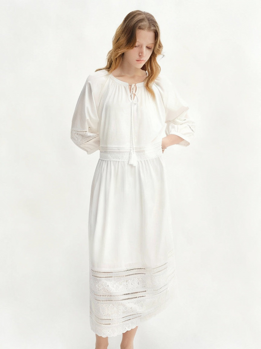 Woman wearing a white dress with long sleeves on a white background, featuring the brand 'DUSHU'.