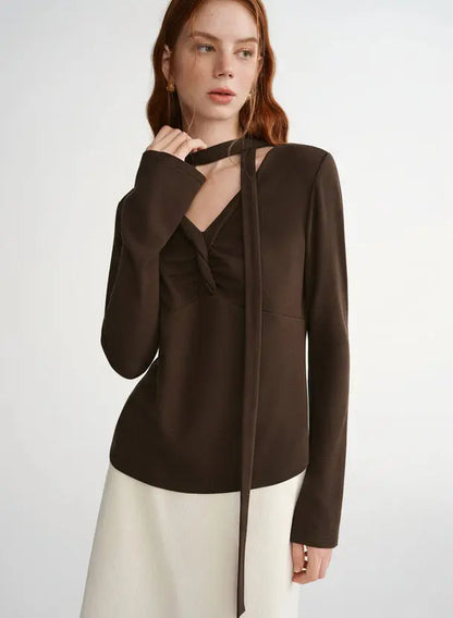 Woman wearing a brown blouse with a white background