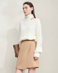 Woman wearing a white sweater and beige skirt with text about eco-friendly mink cashmere yarn and technical details.