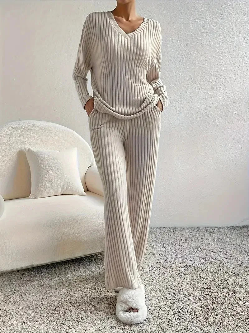 Person wearing a ribbed knit outfit in a minimalistic room.